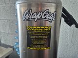 a metal container with a warning sticker on it