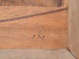 une image montrant un gros plan d'un morceau de bois sur lequel figure une inscription