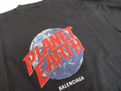 the back of a black shirt with the planet earth logo on it