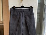grey shorts hanging on a wall in front of a window