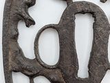a metal object with a bird and star design on it