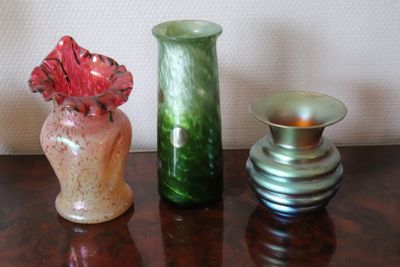 three vases sitting on a table next to each other
