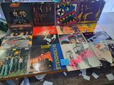 a lot of vinyl records on a table in a room