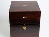 an antique wooden box with brass hardware on a white background