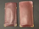 a pair of brown leather cases sitting on top of a table