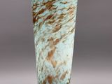 a close up of a vase with a brown and blue design