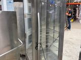 a glass door refrigerator in the middle of a warehouse