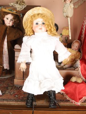 a doll that is sitting on a table with other dolls