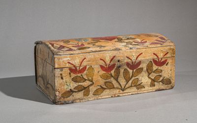 a small wooden box with a floral design on it