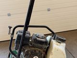 an image of a small lawn mower in a garage