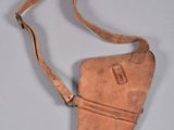 an old leather purse with a strap hanging from it ' s side