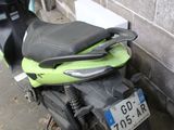 a motorcycle parked next to a brick wall with a license plate on it