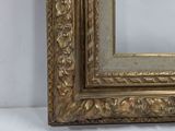 an image of a gold framed mirror sitting on top of a white wall