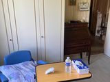 a room with a table, chairs, and a piano in it