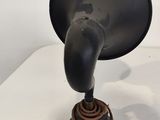 a black object on a white table with a white background