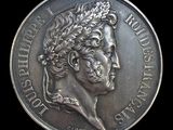 a close up of a silver coin on a black background