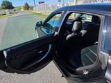 a black car with its door open on the street