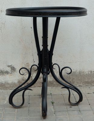 a black table with a black top on a brick floor