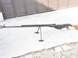 a gun that is sitting on a pole in front of a garage door