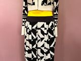 the mannequin is wearing a black and white outfit with a yellow belt