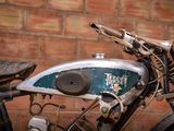 a motorcycle that is parked in front of a brick wall