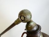 a metal object that looks like a bird with a long beak