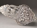 a silver spoon with a design on it sitting on a table