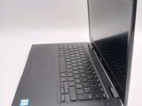 a laptop computer sitting on top of a white table