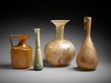 three vases are sitting next to each other on a gray surface
