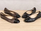 two pairs of black and brown shoes sitting on top of a wooden floor