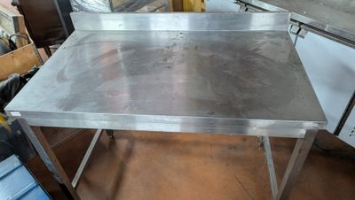 a stainless steel table that is in the middle of a room