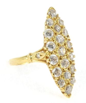 a close up of a gold ring with a cluster of diamonds