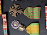 many medals and ribbons on a black surface