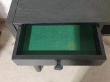 a black table with a green drawer underneath it