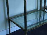 a glass shelf with two glass shelves on top of it
