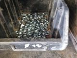 a crate full of cans of soda sitting on the floor