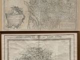 two maps on display on the wall of a room