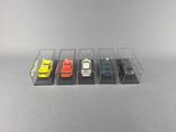 five toy cars in a display case on a table