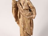 a statue of a man with his hand up in the air