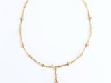 a close up of a necklace on a white surface