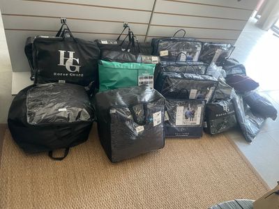many bags of luggage sitting on the floor next to each other