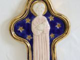 an image of a blue and gold cross with a woman holding a baby