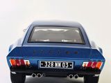 a blue toy car that is sitting on a white surface