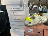 several boxes of tennis shoes are stacked on top of each other