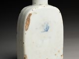 an old white vase with a blue design on the side