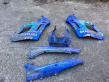 a close up of a blue and black motorcycle fairing kit