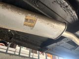 a close up of a car exhaust pipe with a sticker on it