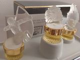 bottles of perfume sitting on top of a tray on top of a table