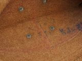 a close up of a brown hat with writing on it