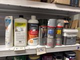 many different types of paint on the shelves in the store